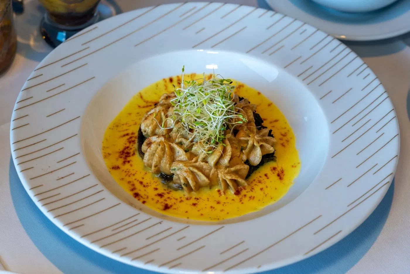 Dumplings served in a saffron broth