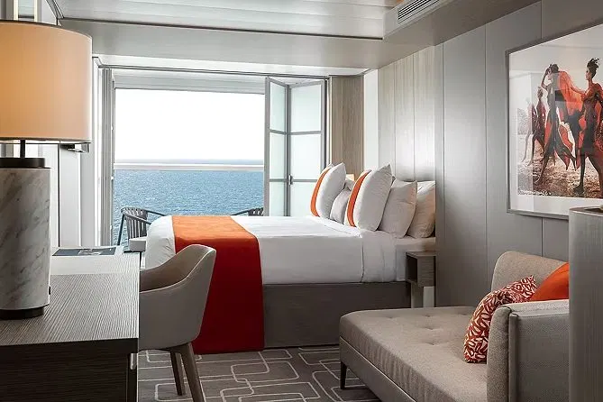 An Infinite Veranda stateroom with the glass doors folded open to the sea