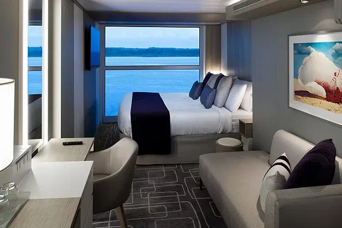 An Ocean View stateroom with a floor-to-ceiling window onto the sea