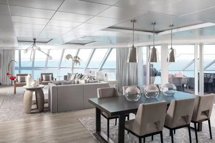 A Retreat suite living and dining room with floor-to-ceiling windows onto the sea