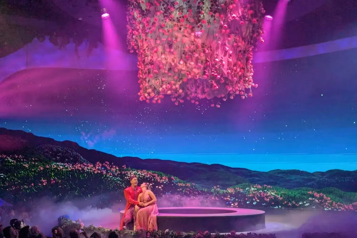 A lone figure at a writing desk as the words The mirror are projected across the LED wall in Between Takes