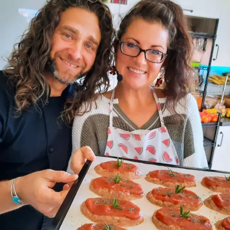 Lissa and Nate Maris, raw vegan educators, with a tray of prepared food